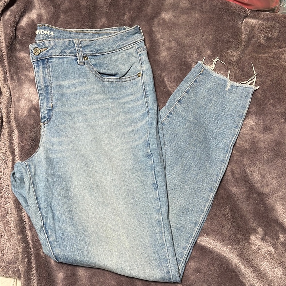 Faded distressed hem light wash skinny jeans